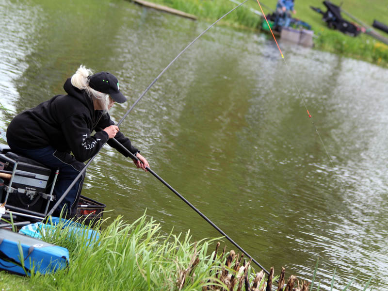 Rita Bell wrestles with an angry carp on Adams lake.
